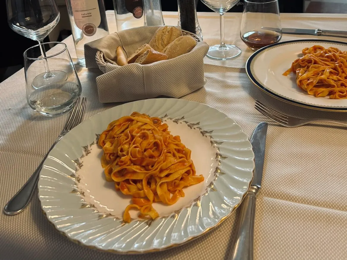 Fresh fettuccine with tomato sauce, served at the table